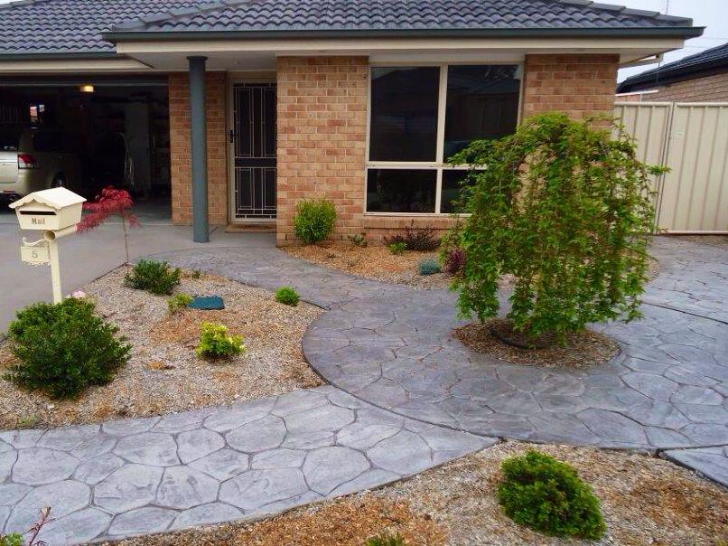 Completed front garden with curved paving, gravel and planted beds